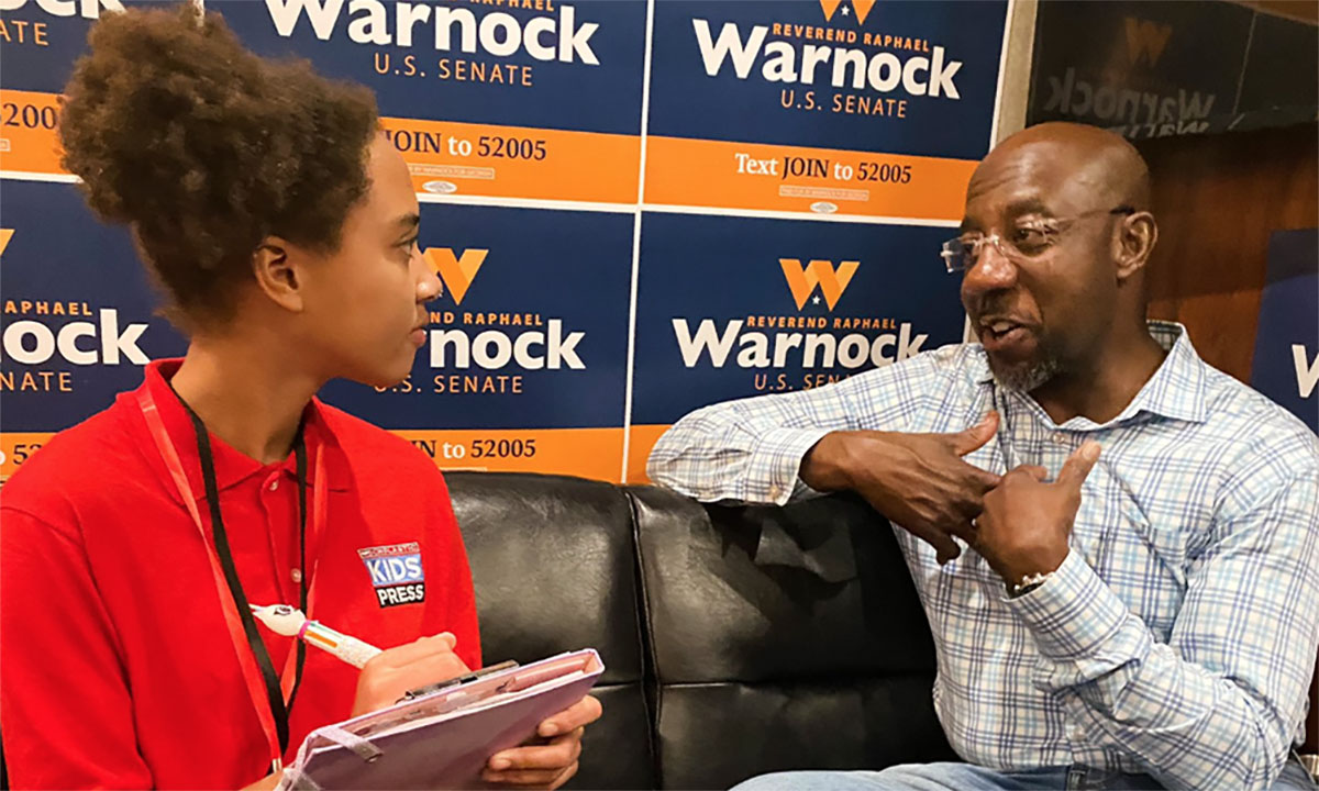 A photo of Skye Oduaran interviewing Georgia Sen. Raphael Warnock, the Democratic incumbent in the state’s Dec. 6 runoff election